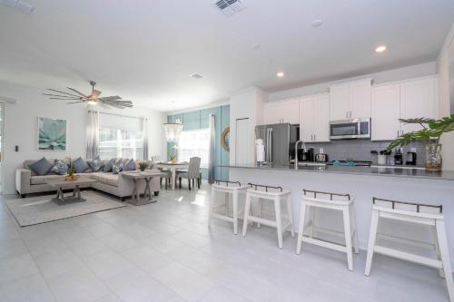 a kitchen and living room with a couch and a table at NEW to Market 5 Bed - Storey Lake Retreat in Kissimmee