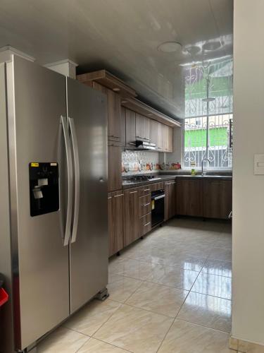 a kitchen with a large stainless steel refrigerator at Apartamento familiar en el centro de Pereira in Pereira