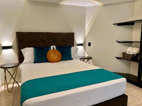 a bedroom with a large bed with blue pillows at Hotel Limamar in Lima
