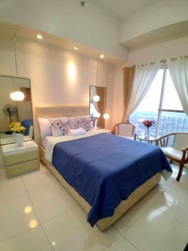 Voodi või voodid majutusasutuse Tagaytay Smdc Wind Residences by Le Grand Liz's Place toas