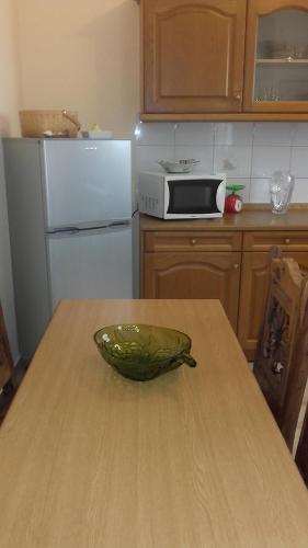 a kitchen with a bowl on a wooden table at Family Apartment in Patra