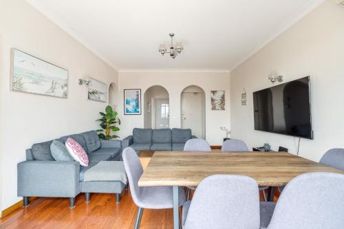 a living room with a couch and a table and chairs at Location, Location, Location in Sydney