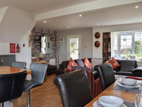 a living room with a couch and a table at Mountain View in Morfa Bychan