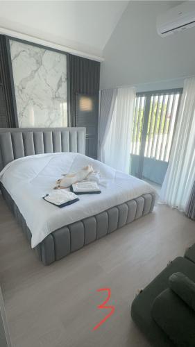 a bedroom with a bed with two people laying on it at Norden Barn B&B in Chiang Mai