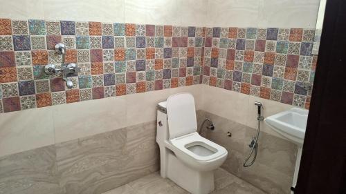 a bathroom with a toilet and a sink at Riddhi Homestay in Dahmi
