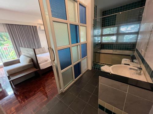 a bathroom with a sink and a tub and a toilet at Molecular cloud in Pattaya North
