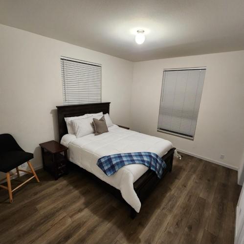 a bedroom with a bed and a chair in it at Home away from Home - 6 miles from the SNP in Three Rivers