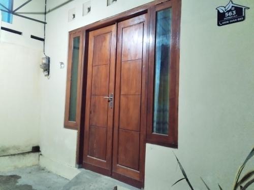 a wooden door on the side of a building at 563 Homestay Jogja in Ngabean