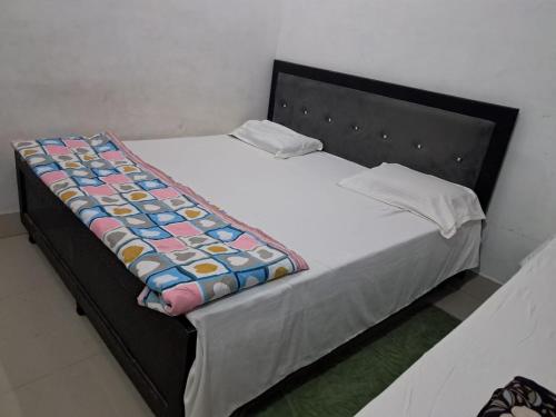 a bed in a room with at Vrindavan Homestay in Vrindāvan