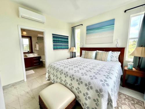 a bedroom with a large bed and a bathroom at Wyakha 4 Ocean View in Long Bay Hills