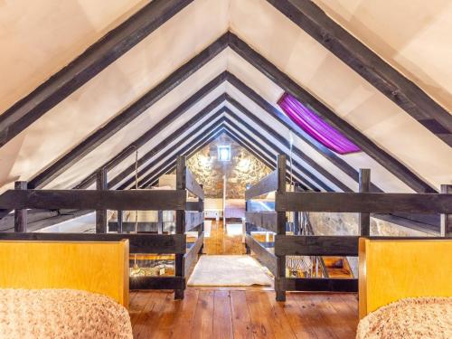 a room with a roof with wooden beams at Rustical Resort Kokori i Shared Pool - One Bedroom in Višnjica