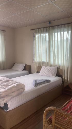 Ένα ή περισσότερα κρεβάτια σε δωμάτιο στο Nagarkot New Homestay
