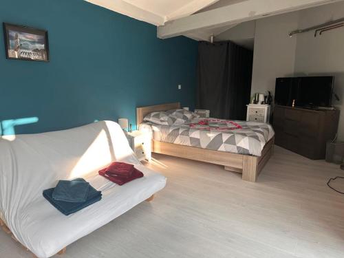 a bedroom with two beds and a tv in it at Chambre pour 4 personnes avec SdB privative et jacuzzi in Le Petit-Couronne