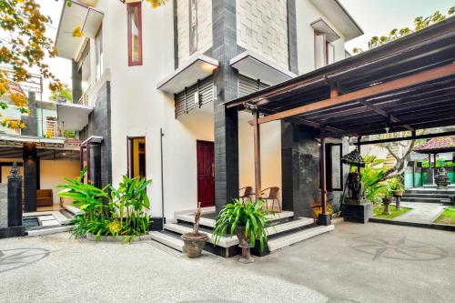 a building with plants in front of it at 5-Bedroom Private Villa near Padma Beach, Legian in Legian