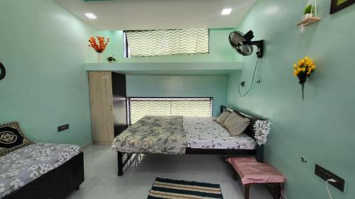 a bedroom with a bed and a window at Private room in a residential area in Hospet