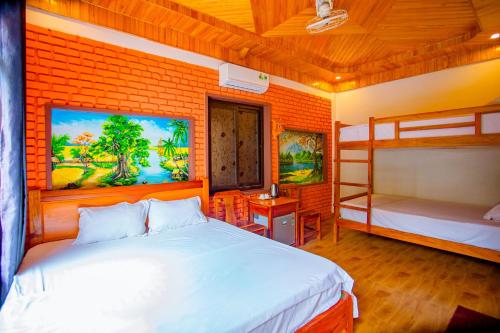 a bedroom with a bed and bunk beds in it at Hillside Homestay in Dong Hoi
