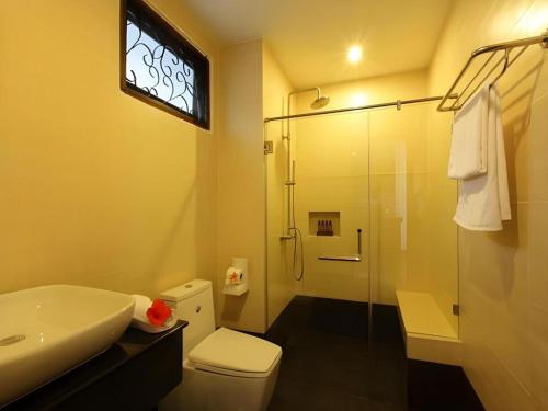 a bathroom with a shower and a toilet and a sink at Maryoo Samui Hotel in Chaweng