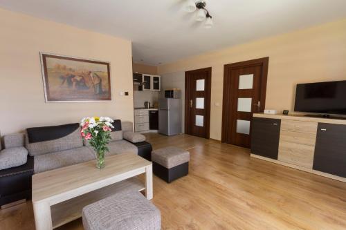 a living room with a couch and a table at Zagroda Nad Kotelnią in Pawłowa