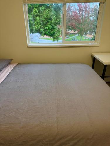 a bed in a room with a window at Maple & Moon in Richmond