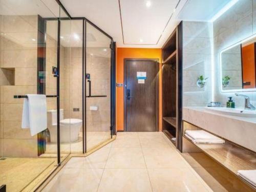 a bathroom with a shower and a toilet and a sink at Jinjiang Inn Select Shanghai International Resort Area East Kangqiao Road in Shanghai