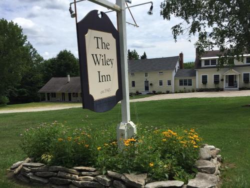 a sign for the valley inn in a field of flowers at Wiley Inn in Peru