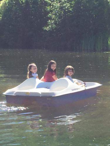 three girls riding in a white boat on the water at Wiley Inn in Peru