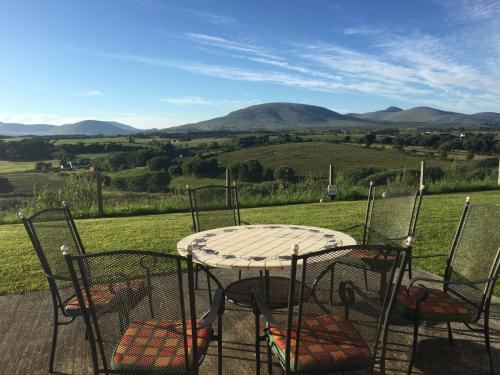 a table and chairs with a view of a field at Western Greenway B&B in Newport