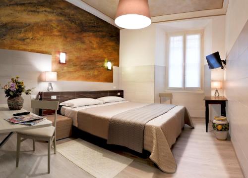 a bedroom with a large bed and a table at Albergo Annabella in Santa Margherita Ligure