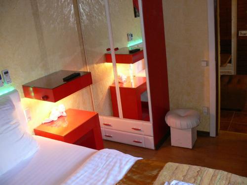 a bedroom with a bed and a dresser and a mirror at ApartHotel Dom in Odesa