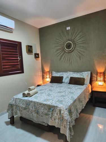 a bedroom with a large bed in a room at Maragogi Chalé Antunes in Maragogi