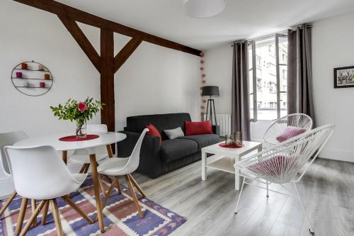 ein Wohnzimmer mit einem Sofa, einem Tisch und Stühlen in der Unterkunft Fontainebleau Sweet Home in Fontainebleau