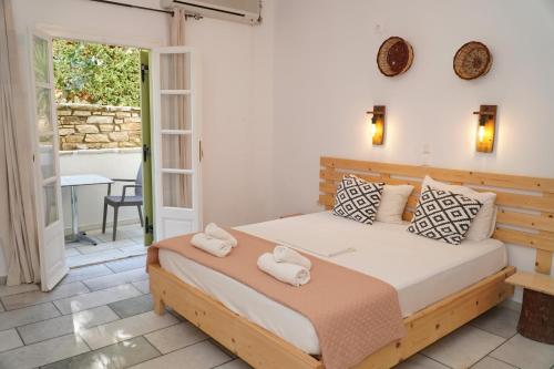 a bedroom with a bed with towels on it at Camara Hotel in Agios Prokopios