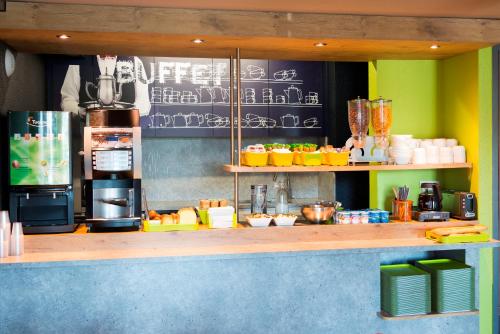 a counter in a restaurant with a chalkboard at ibis budget Granville in Granville