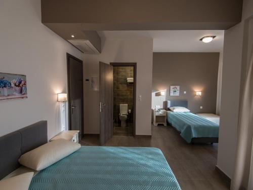 Postel nebo postele na pokoji v ubytování Harmony Hotel