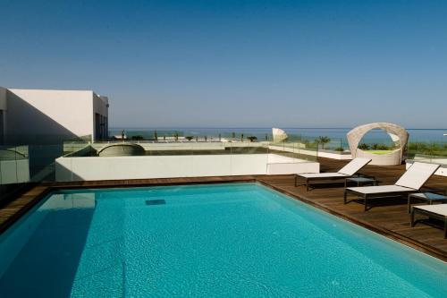 a swimming pool with a view of the ocean at Royal Thalassa Monastir in Monastir