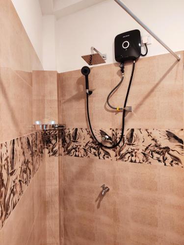 a bathroom with a shower with a camera on the wall at ANTONIO TRANSIT KATUNAYAKE in Katunayaka