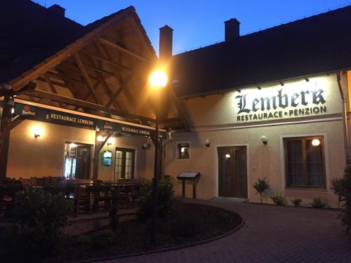 a building with a street light in front of it at Penzion a restaurace Lemberk in Jablonné v Podještědí