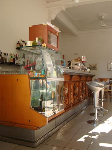 a glass display case in a kitchen with a counter at Hotel Miramare in Lavagna