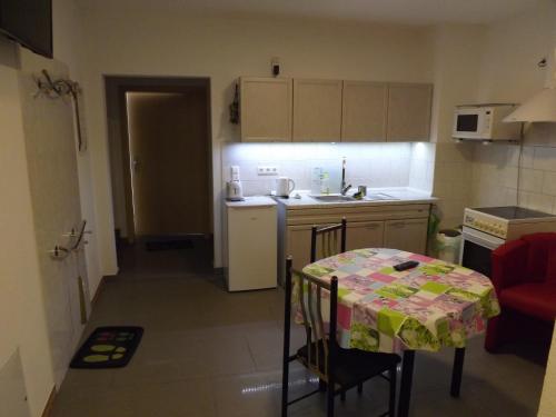 a small kitchen with a table with a table cloth on it at Ferienwohnung Sowade in Nebra