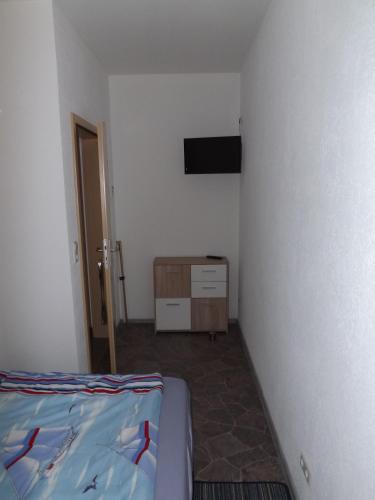 a bedroom with a bed and a flat screen tv at Ferienwohnung Sowade in Nebra