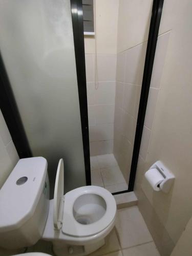 a small bathroom with a toilet and a shower at Z Crib Solana in Bacolor