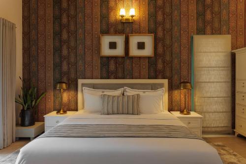 a bedroom with a large white bed in a room at Mammootty House Kochi - a VKation Experience in Cochin