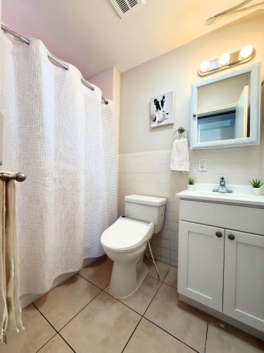 a bathroom with a toilet and a sink at 3 Bedroom Smart Apartment Sleeps 11 just 20 min to Times Square in West New York