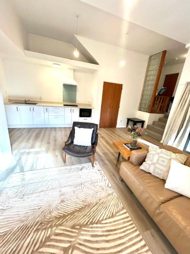 a living room with a couch and a table at St Okes Apartment- Peaceful retreat set in native bush Stay 1 night, 1 week or 1 month in Lower Hutt