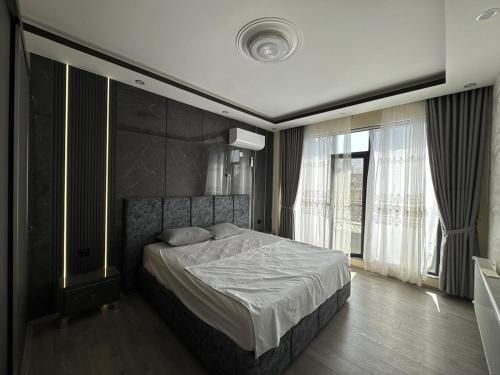 a bedroom with a bed and a large window at Welcome to your home away from home! in Kabul