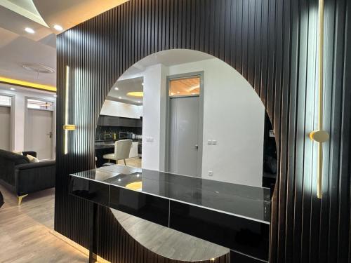 a black wall with a mirror in a room at Welcome to your home away from home! in Kabul