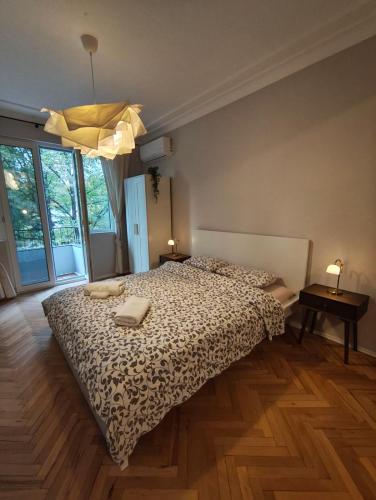 a bedroom with a bed with two towels on it at Serenity Lodge, next to NDK in Sofia