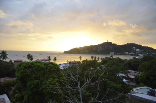 a view of the beach at sunset from a resort at Nuestra Casa in San Juan del Sur
