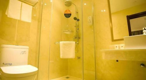 a bathroom with a shower with a toilet and a sink at GreenTree Inn Fuzhou Dongxiang Longshan Express Hotel in Fuzhou