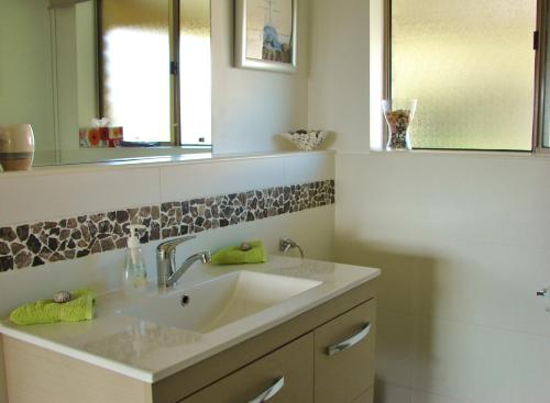 a bathroom with a sink and a mirror at Austiny Bed and Breakfast Victor Harbor in Victor Harbor